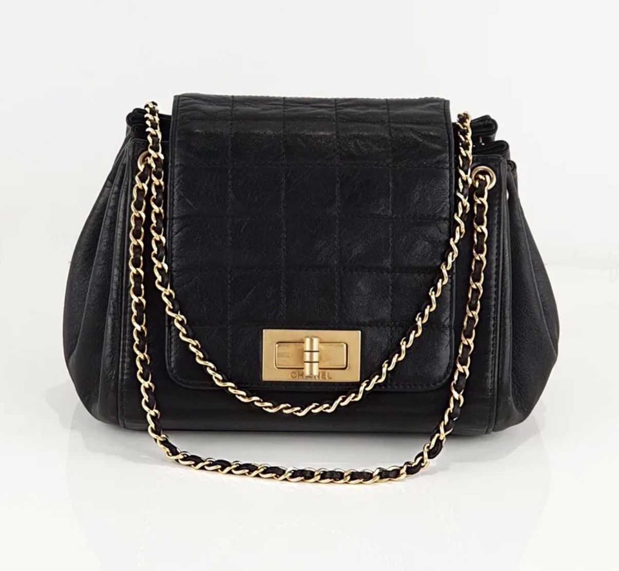 Black quilted Chanel Accordion Flap Bag with gold-tone hardware
